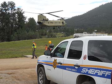 Chinook and Sheriff's vehicle
