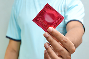 man holding a condom