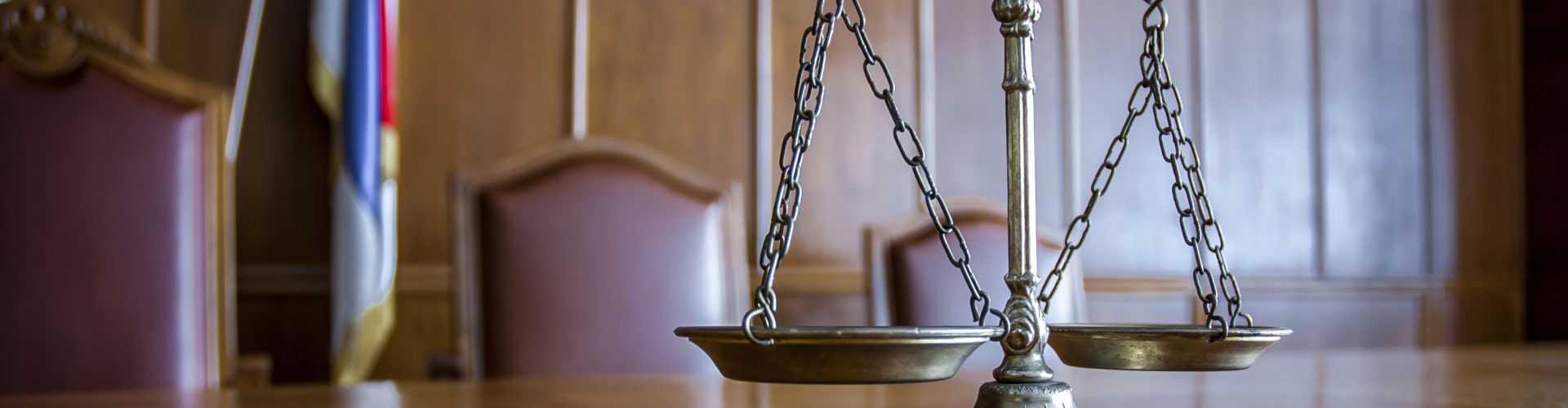 Scales of justice on a table in a courtroom