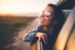 woman in a car feeling free